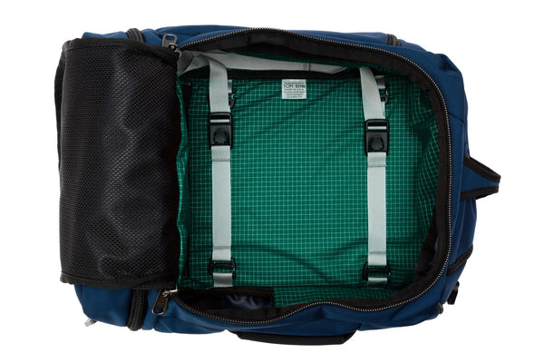 A Techonaut 30 with a Deep Blue (dark blue) exterior with Sitka (dark green with white grid pattern) 200 Halcyon interior.
